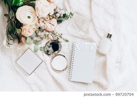 Flat lay scene made with cosmetics accesories, elegant flowers bouquet and empty mockup spiral notebook. Flat lay scene made with cosmetics accesories, elegant flowers bouquet and empty mockup spiral notebook. 99720704