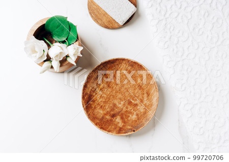Minimalist composition for beauty skin care product presentation made with mockup wooden pedestal and pumice stones near white towel, top view. Minimalist composition for beauty skin care product presentation made with mockup wooden pedestal and pumice stones near white towel, top view. 99720706