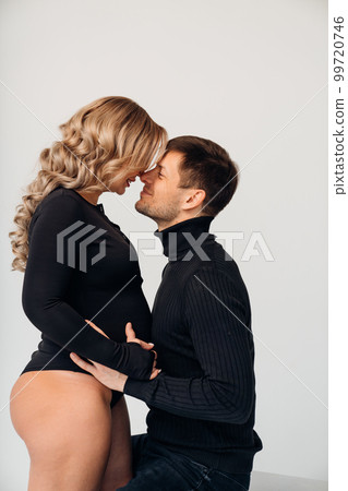 a loving and passionate man and woman in black expecting a child. a loving and passionate man and woman in black expecting a child. 99720746