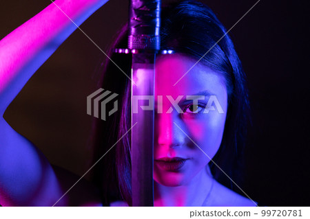 Neon lights. Beautiful asian woman with katana sword. Neon lights. Beautiful asian woman with katana sword. 99720781