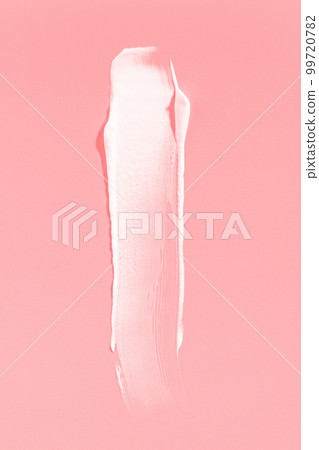 White cream smear on a pink background. Vertical macro photography. White cream smear on a pink background. Vertical macro photography. 99720782