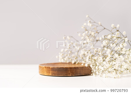 Beauty cosmetic product presentation scene made with a wooden plate and wild flowers. Summer mood background. Front view. Beauty cosmetic product presentation scene made with a wooden plate and wild flowers. Summer mood background. Front view. 99720793
