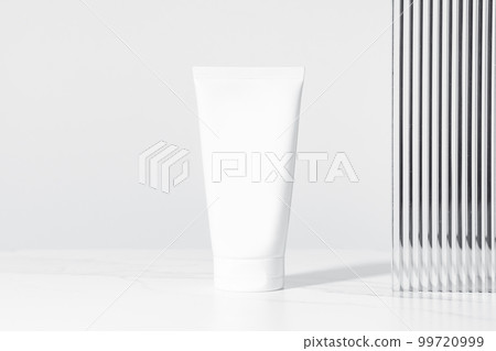 Minimal composition of white plastic mockup cosmetic or cream tube. Studio photography. Minimal composition of white plastic mockup cosmetic or cream tube. Studio photography. 99720999