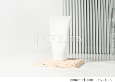 Empty white plastic mockup cosmetic, cream bottle standing on a bathroom shelf. Studio photography. 99721000