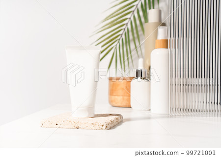 White plastic mockup cosmetic, cream tube standing on a bathroom shelf. Studio photography. White plastic mockup cosmetic, cream tube standing on a bathroom shelf. Studio photography. 99721001