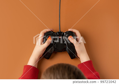 Little boy holding game radio remote control in his hands. 99721042