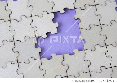 Missing heart-shaped puzzles. A background of puzzles with a light purple empty space. Missing heart-shaped puzzles. A background of puzzles with a light purple empty space. 99721293