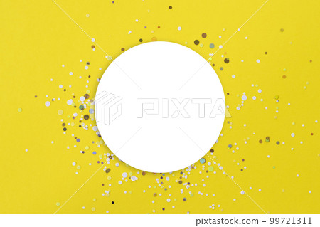 Yellow background with a white round mock-up in the center. With gold confetti glitter around it. 99721311