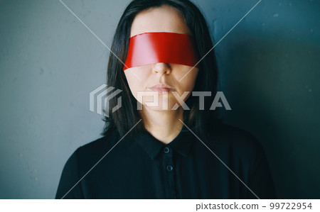 Woman with red adhesive tape on the eyes 99722954
