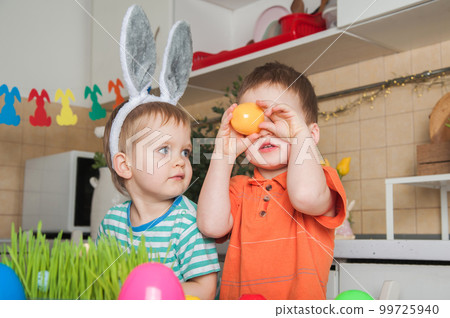 Children painting Easter eggs at home. Easter traditions, fun with toddlers. Children painting Easter eggs at home. Easter traditions, fun with toddlers. 99725940