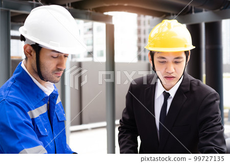 Professional Asian foreman and construction manager talking - discussing about building structure plant together. Businessman and construction engineer having a discussion. Professional Asian foreman and construction manager talking - discussing about building structure plant together. Businessman and construction engineer having a discussion. 99727135