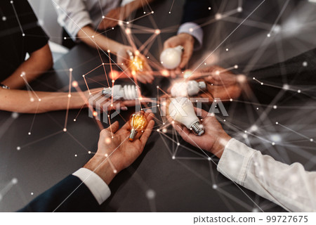 Teamwork and brainstorming concept with businessmen that share an idea with a lamp 99727675