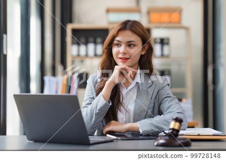 Business Lawyer consulting online on laptop while working at office. 99728148