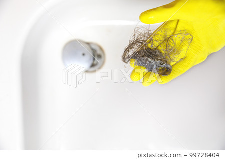 Shower drain is clogged with hair, Hair pile loss in a bathroom after wash hair in shower, cleaning bathroom and removing hair top view Shower drain is clogged with hair, Hair pile loss in a bathroom after wash hair in shower, cleaning bathroom and removing hair top view 99728404