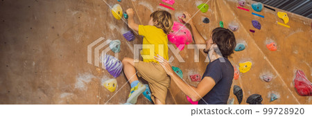 Dad and son at the climbing wall. Family sport, healthy lifestyle, happy family BANNER, LONG FORMAT Dad and son at the climbing wall. Family sport, healthy lifestyle, happy family BANNER, LONG FORMAT 99728920