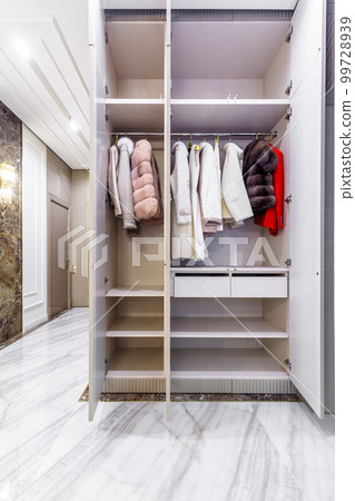 Modern built in wardrobe with closet. Assortment of Russian fur coats 99728939