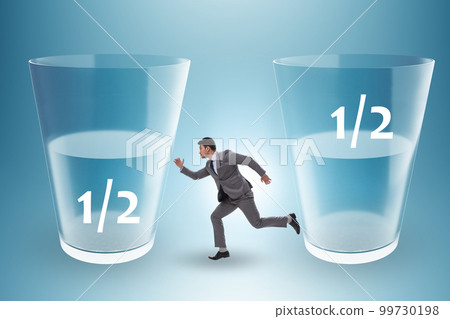 Businessman in half empty half full glass concept 99730198