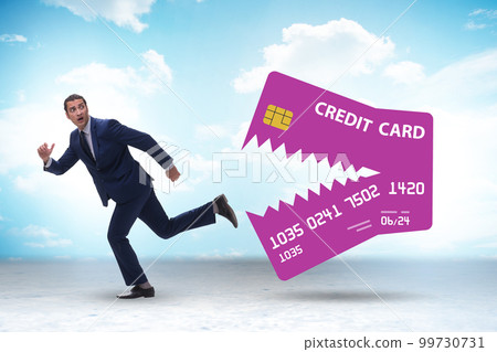 Businessman in credit card debt concept Businessman in credit card debt concept 99730731