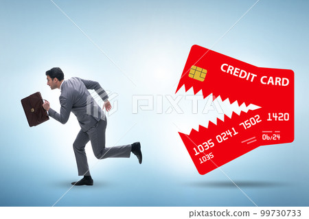 Businessman in credit card debt concept Businessman in credit card debt concept 99730733