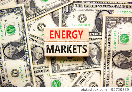 Energy markets symbol. Concept words Energy markets on wooden block. Beautiful background from dollar bills. Dollar bills. Business energy markets concept. Copy space. Energy markets symbol. Concept words Energy markets on wooden block. Beautiful background from dollar bills. Dollar bills. Business energy markets concept. Copy space. 99730889