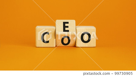 CEO or COO symbol. Concept word CEO chief executive officer or COO chieve operating officer on wooden cubes. Beautiful orange table orange background. Business and CEO or COO concept. Copy space. 99730905