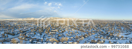 cold winter sunrise over residential area of Fort Collins and Rocky Mountains foothills in northern Colorado, aerial panorama view 99731088