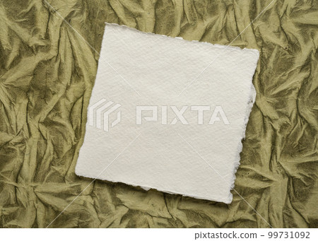 small sheet of blank white Khadi rag paper against art paper background 99731092