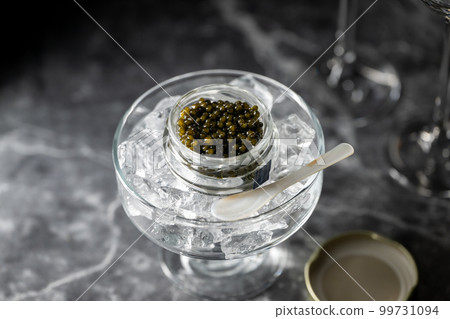 black caviar on ice with pearl spoon 99731094