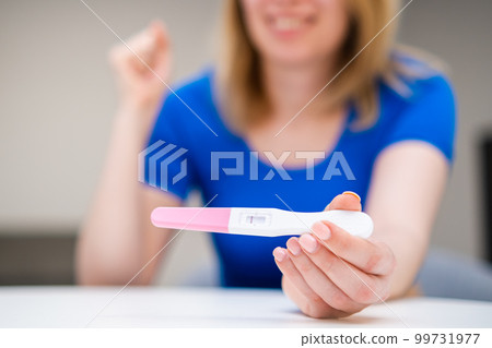 Say yes getting a negative pregnancy test. Happy young woman not ready to have a baby  99731977