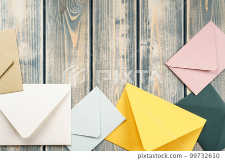 Multicolored envelopes lie randomly on gray wooden background. Copy space. Top view. Mail, correspondence 99732610