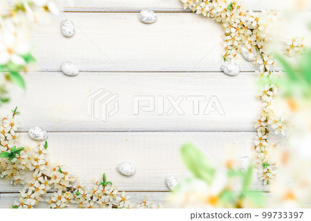 Easter flat. Cherry tree blossom, white happy easter eggs on wood spring background. Springtime concept. Easter flat. Cherry tree blossom, white happy easter eggs on wood spring background. Springtime concept. 99733397