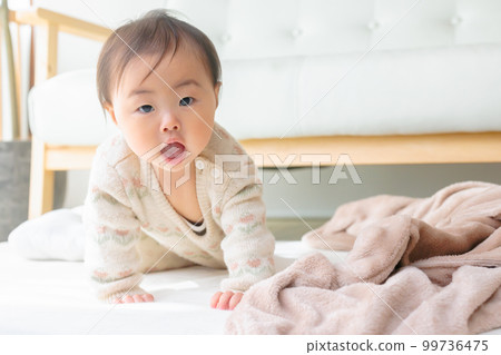 Baby getting out of bed while talking Baby getting out of bed while talking 99736475