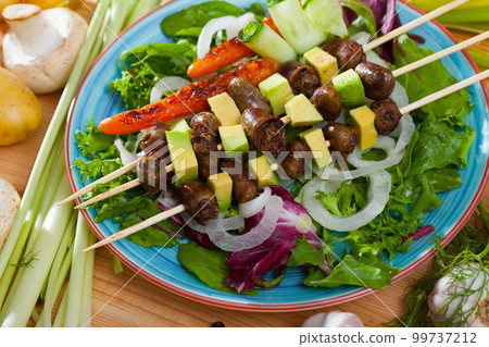 Chicken hearts skewers with avocado 99737212