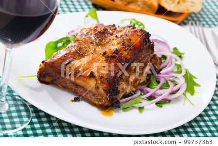 Roasted pork rack of ribs with greens Roasted pork rack of ribs with greens 99737363