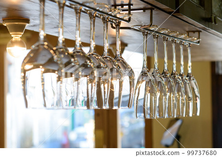 wine glasses hanging in glass holders 99737680