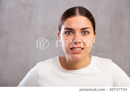 Close-up portrait of young woman with angry expression on face 99737734