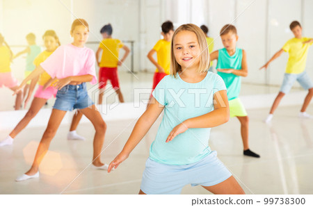 Group of kids training modern dance moves Group of kids training modern dance moves 99738300