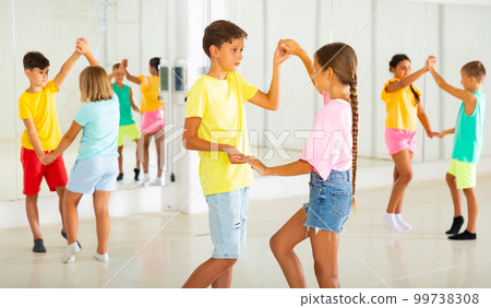 Active young children enjoying of partner dance in class 99738308