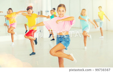 Young girls and boys performing dance in studio Young girls and boys performing dance in studio 99738387