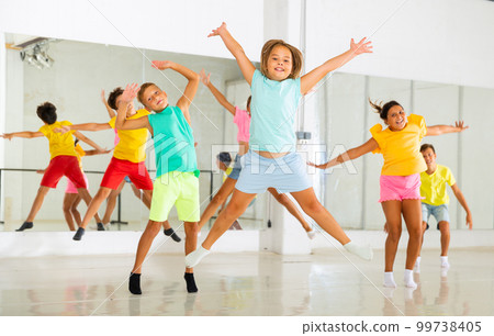 Happy sporty kids jumping in modern dance studio Happy sporty kids jumping in modern dance studio 99738405