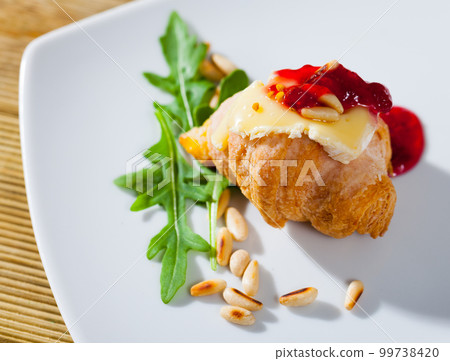 Croissant with camembert, jam and pine nuts 99738420