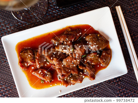 Japanese dish - wok with veal and sesame seeds Japanese dish - wok with veal and sesame seeds 99738472