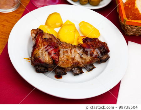 Portion of honey glazed beef ribs with potato Portion of honey glazed beef ribs with potato 99738504