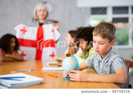 students listen to woman teacher who talks about Georgia 99738559