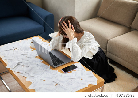 A woman buried in a large amount of receipts 99738585