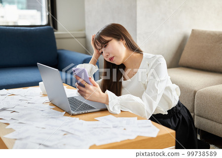 A woman buried in a large amount of receipts A woman buried in a large amount of receipts 99738589