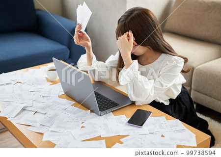 A woman buried in a large amount of receipts 99738594