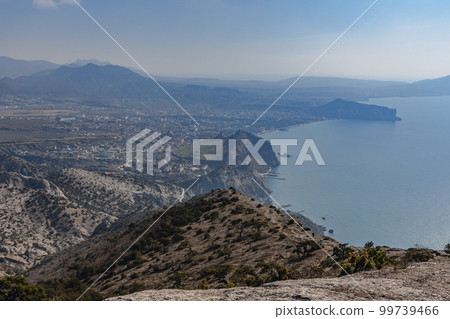 View on Sudak, sea, mount and cape from the top of Falcon Sokol mountain at morning . Crimea 99739466