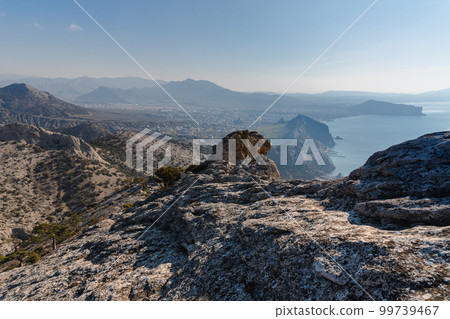 View on Sudak, sea, mount and cape from the slope of Falcon Sokol mountain at morning . Crimea 99739467