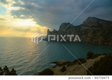 View of Karaul-Oba mountain,Cape Chicken-Kaya and Blue bay on sunset. Noviy Svet. Crimea 99739475